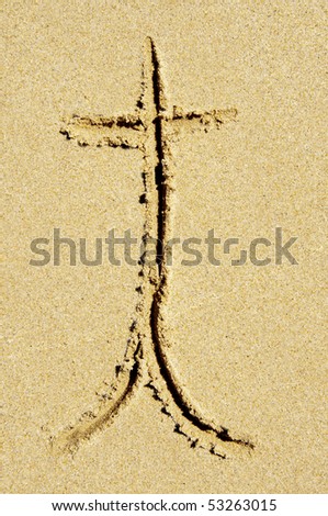 t letter written in the sand on a beach