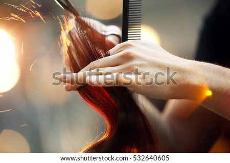 Hairdresser cutting and modeling brown hair by scissors and comb

 Royalty-Free Stock Photo #532640605