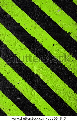 Black and green diagonal lines on a concrete background