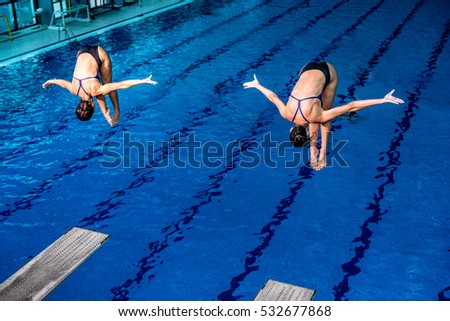 Two female divers on training or on competition.  Royalty-Free Stock Photo #532677868