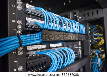 Ethernet cables and path panel in rack cabinet Royalty-Free Stock Photo #532689088