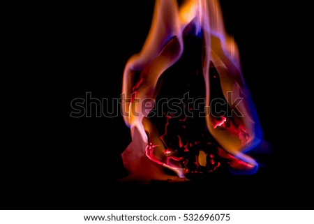 Beautiful concept flames. Fire on burns paper with black background. Soft Focus