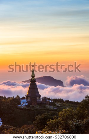 Landscape of two pagoda (noppha methanidon-noppha phon phum siri stupa) 
in sunrise time with mist in the backgroundat at Inthanon mountain, chiang mai, Thailand