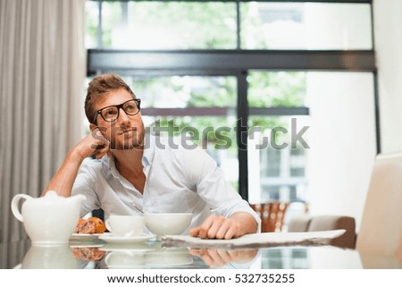 Smiling man sitting at breakfast