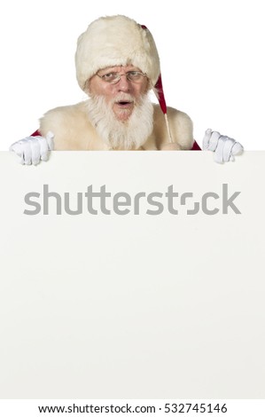 Authentic looking santa claus with a real beard displaying a white sign for copy space and  isolated on white background