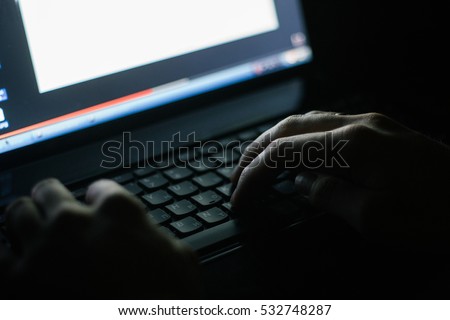 Russian hacker hacking the server in the dark Royalty-Free Stock Photo #532748287