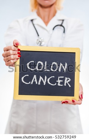 Colon Cancer Chalkboard Sign Held By Female Doctor. Vertical Orientation.