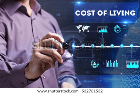 Technology, Internet, business and marketing. Young business person sees the word: cost of living