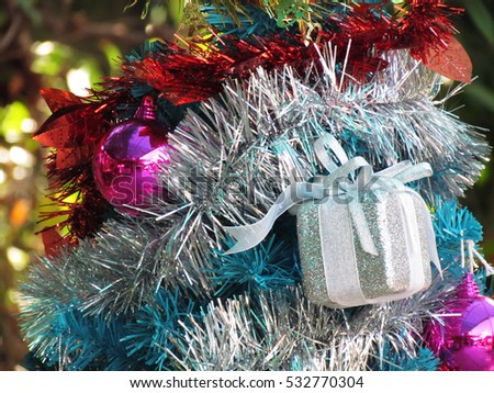 Decorated christmas tree with colorful ornaments, on nature background.