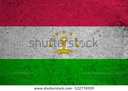 Tajikistan flag on an old grunge background
