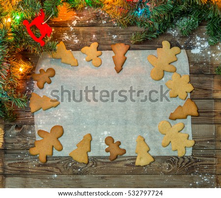 Christmas gingerbread on paper on festive wooden table