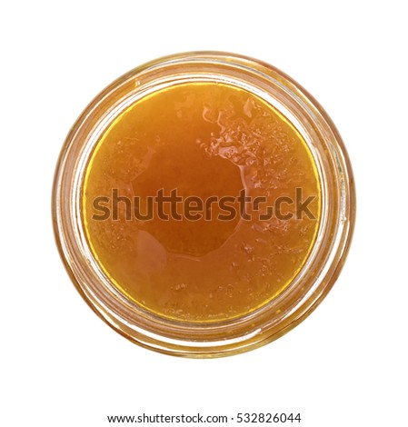Top view of sugar free apricot preserves in an opened glass jar isolated on a white background.