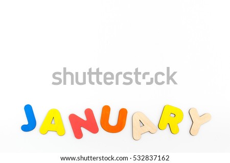 Word of the wooden letters painted in watercolor on laid out on a white background.
Bright colored inscription names the winter months. January