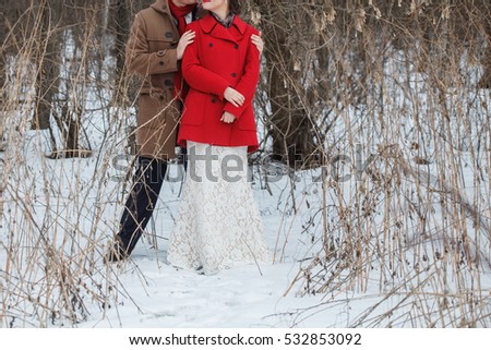 Close winter portrait of young couple in love, hug , wear stylish warm coat. A romantic mood. The concept of holidays.
