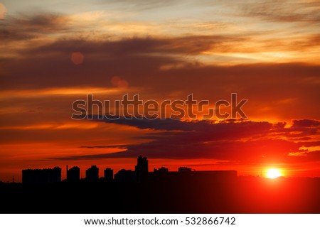 Sunrise in city landscape. Urban sunset. Rays of the sun above the town. Air photography. Dawn of a new day 