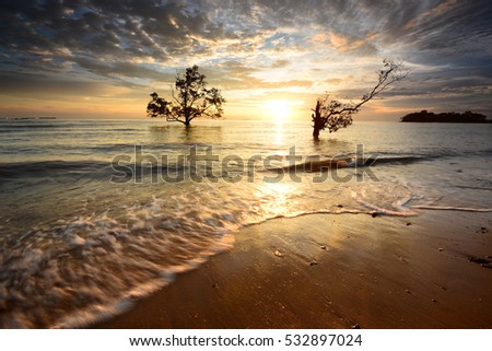 Beautiful view of sunset scenery at seascape. Motion blur on foreground or wave due to slow shutter speed shot. Composition of nature.