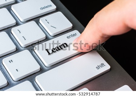 Finger on computer keyboard keys with learn word
