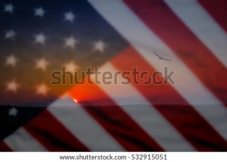 Old American flag background for Memorial Day or 4th of July, eagle and sunset in a scenic foreground and blurred out flag in the backdrop
