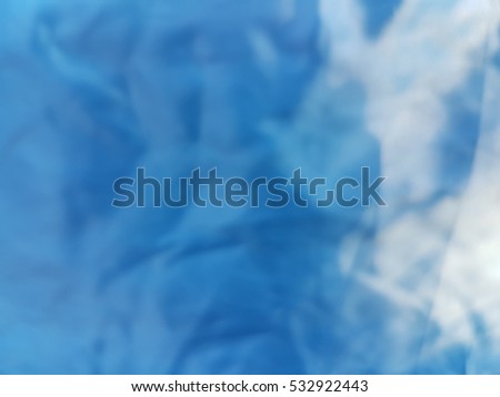 Blurred blue creased fabric with light reflection texture used for background design