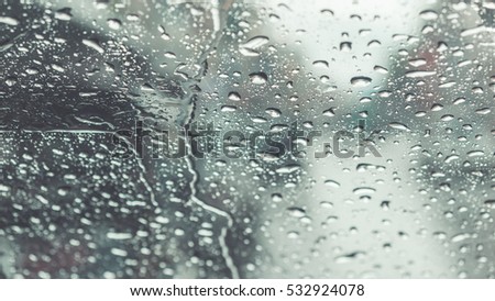 Pictures of water droplets on a windshield blurry background. (vintage style)