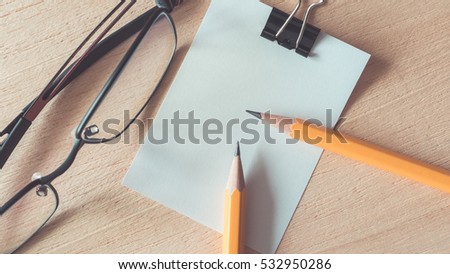 Pictures of stationery ;  pastel yellow pencils, glasses and blank paper. (vintage style)