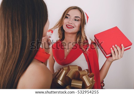 Girl decorate the Christmas tree. give gifts. pictures. good time