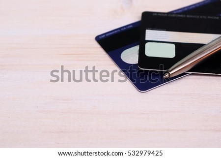 2 credit cards and pen on white wood background, concept on personal finance with copy space