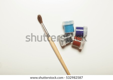 Painting brush with paint and colorful paint on white background