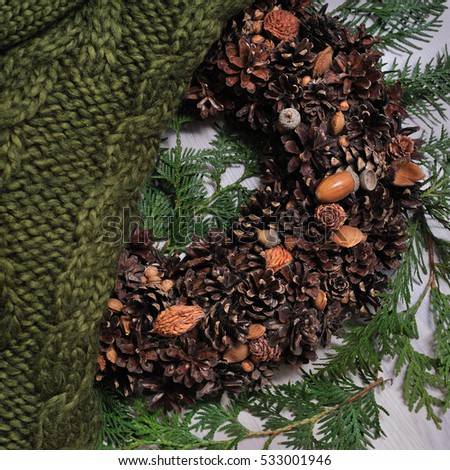 New Year wreath with knitte sweater wooden background
