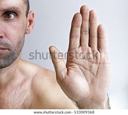 Man showing a stop on a white background