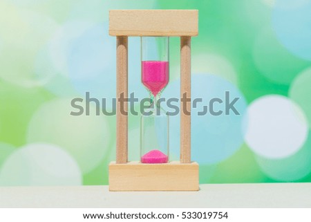 Hourglass Against Green Background