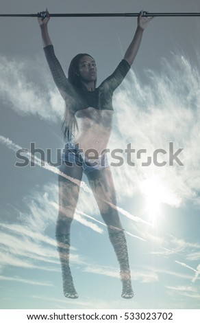 Double exposure of african woman with gorgeous body and cloudscape