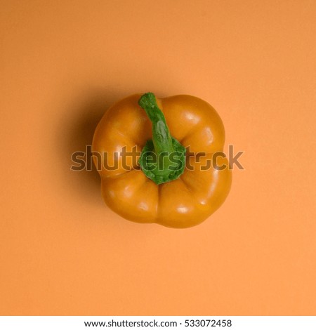 Fresh orange paprika on red backround - Top view