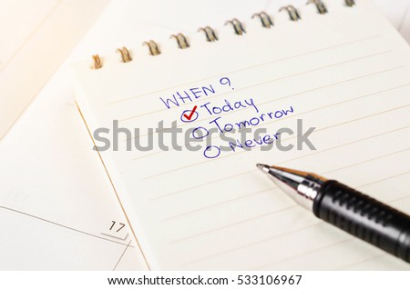 Choosing the right date on diary with calendar page with pen. Time management concept.