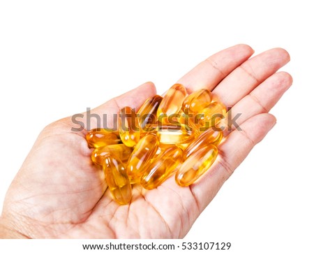 Fish oil pills in female hand isolated on white background, Saved clipping path.