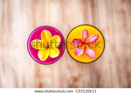 colorful juices and frangipani flowers