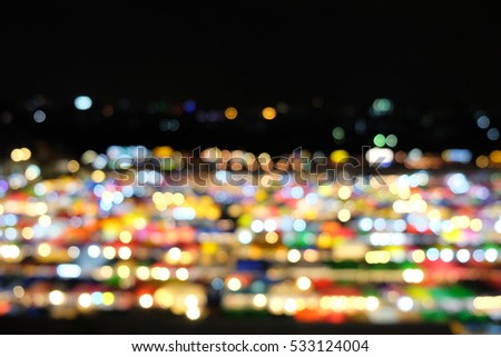 Colorful bokeh light of night market on Ratchada Train Market, Bangkok, Thailand