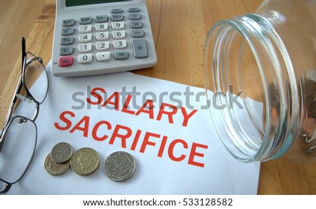 Salary sacrifice with coins on paper and in pot and calculator behind Royalty-Free Stock Photo #533128582