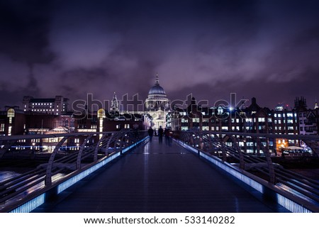 Millennium Bridge London on cloudy night with St Paul's Cathedral in the background.