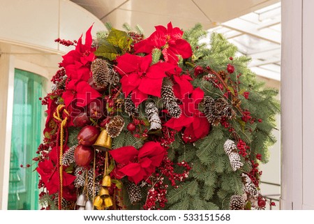 Christmas decoration. Yellow Bell. Red Guelder rose. Cones sprinkled with snow