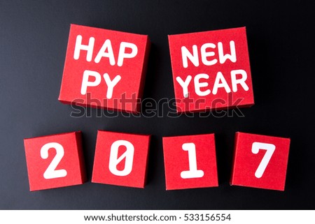 Happy new year 2017 number on red paper box cubes on black background with copy space.Year of the Cock 2017 New Year concept background.
