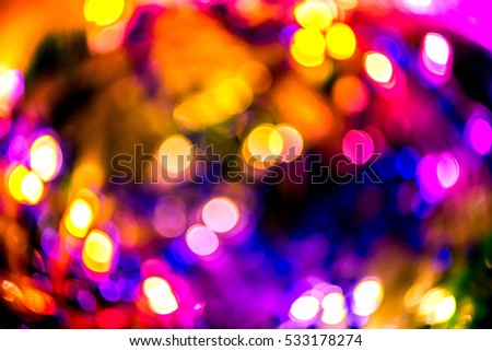 Abstract, blurry, vibrant and colorful background. A shot of Christmas lights on a lit Christmas Tree 
