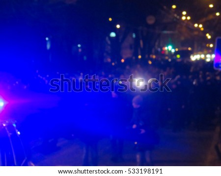  Blurred police car on the street at night. Orange cones set up to direct traffic around a police car in the collision scene. Great background blur                               