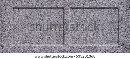 The texture of solid granite tiles. Hard and slippery gray granite surface with a relief discharge when exposed to sunlight