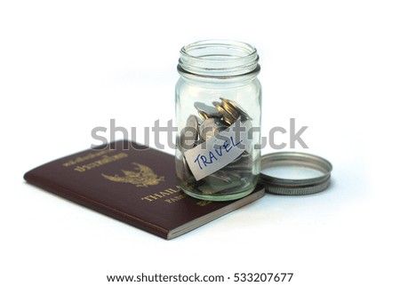 Collecting money for travel. Glass tin as moneybox with cash savings (banknotes and coins) White background, passport