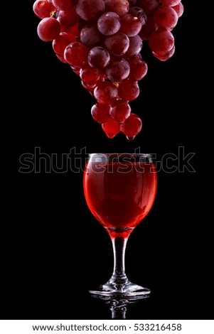 Wine glass and red grapes