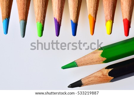 Flat lay view of colored pencils on white background.