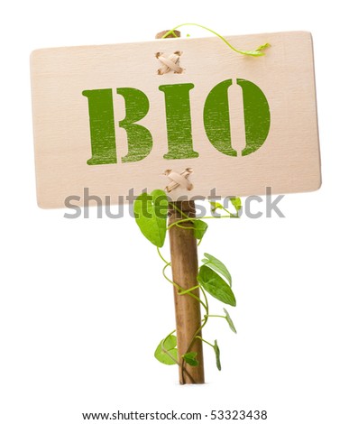 bio sign message on a wooden panel and green plant - image is isolated on a white background