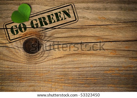 wooden background with green natural heart and go green message Royalty-Free Stock Photo #53323450