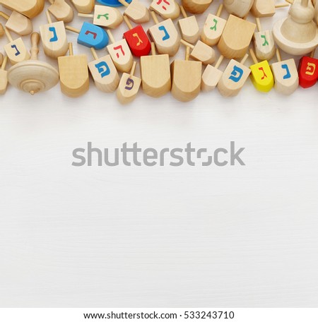 Image of jewish holiday Hanukkah with wooden dreidels (spinning top)

